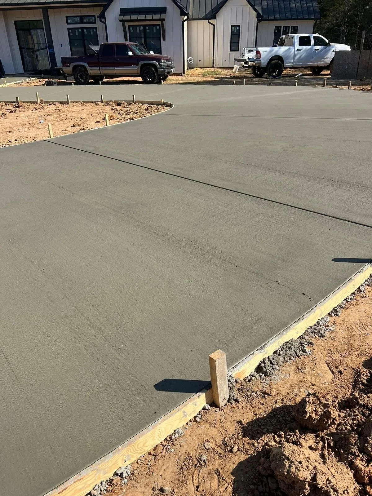 Newly poured concrete driveway in front of a house
