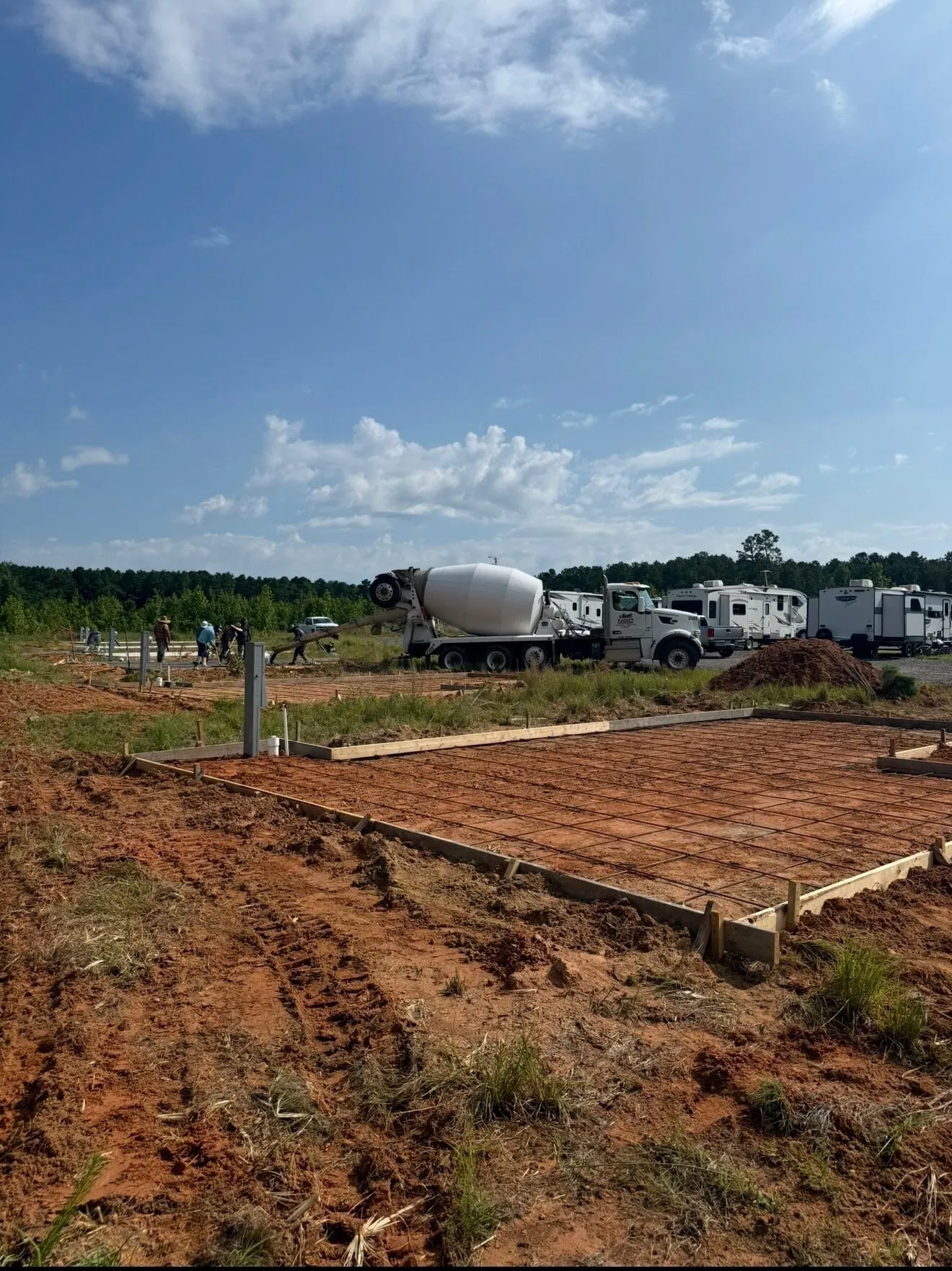 Formed slab ready to pour, with a mixer truck on site