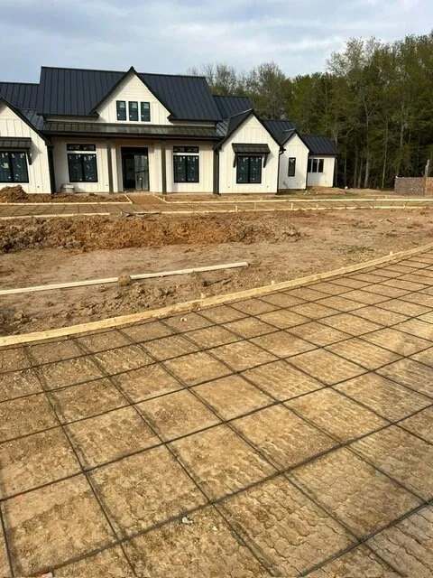 House pad with a rebar grid set in front of a new home