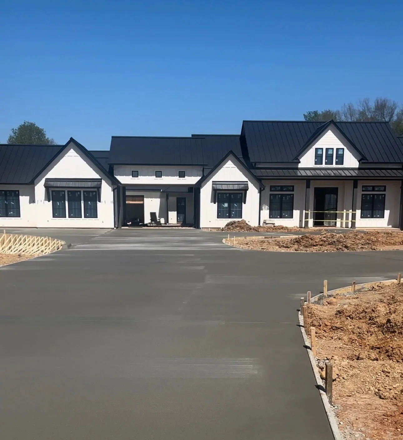 New concrete driveway in front of a newly built home