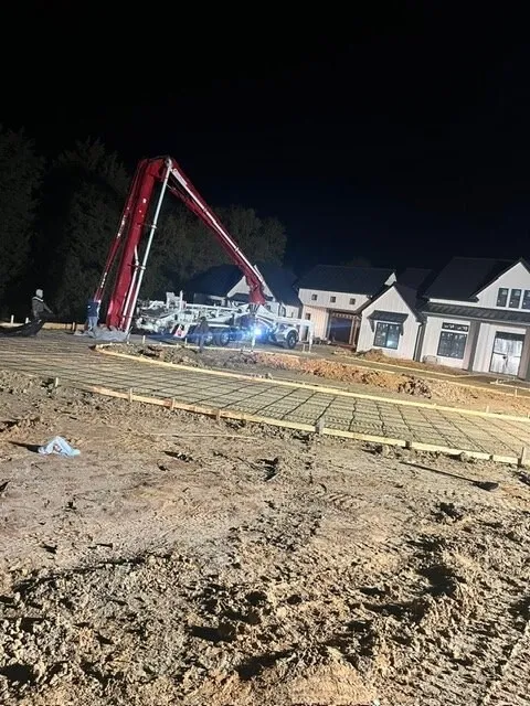 Concrete pump truck working a night pour at a new home