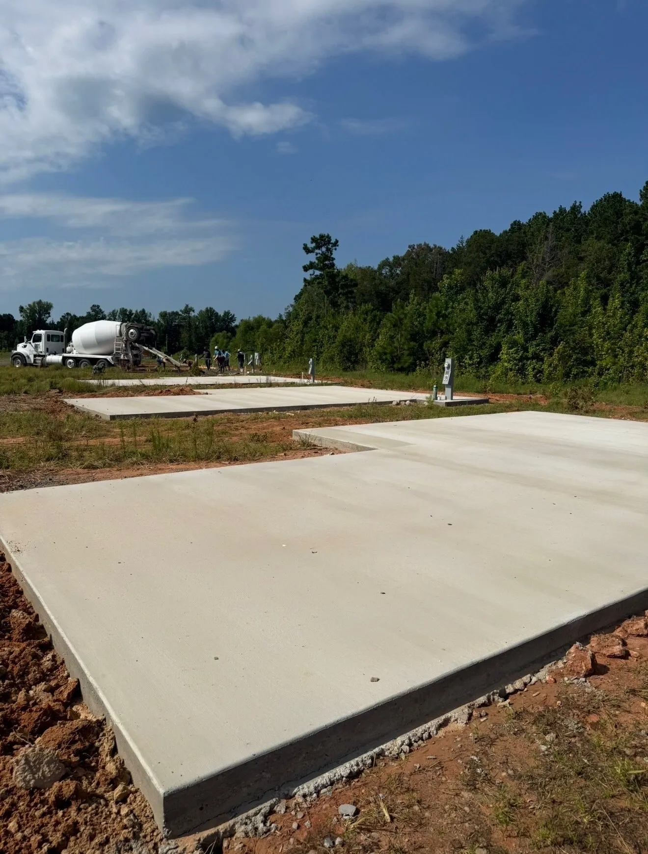 Finished concrete slab with a concrete truck in the background